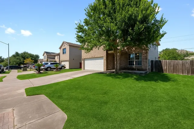 a view of a house with backyard and porch