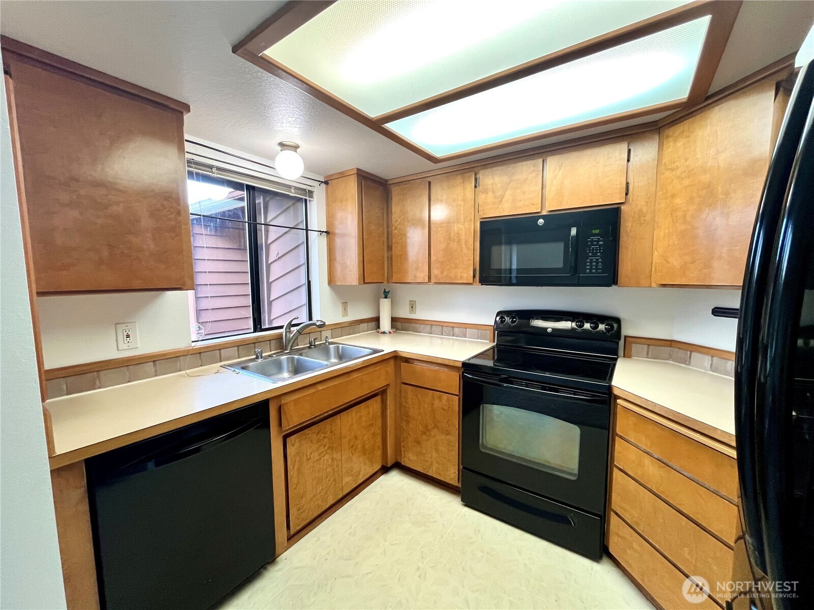 220 North Govan Avenue Sequim, WA 98382 - Photo 6 of 29 a kitchen with a sink stove and microwave