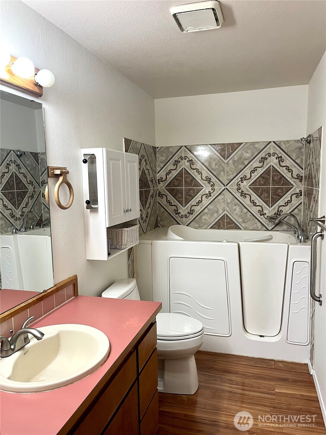 220 North Govan Avenue Sequim, WA 98382 - Photo 10 of 29 a bathroom with a sink a toilet and a mirror