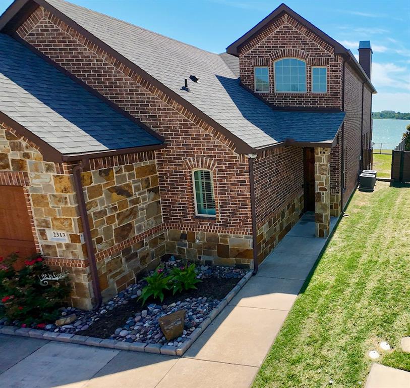 2313 Windjammer Way Rowlett, TX 75088 - Photo 2 of 38 a front view of a house with a yard