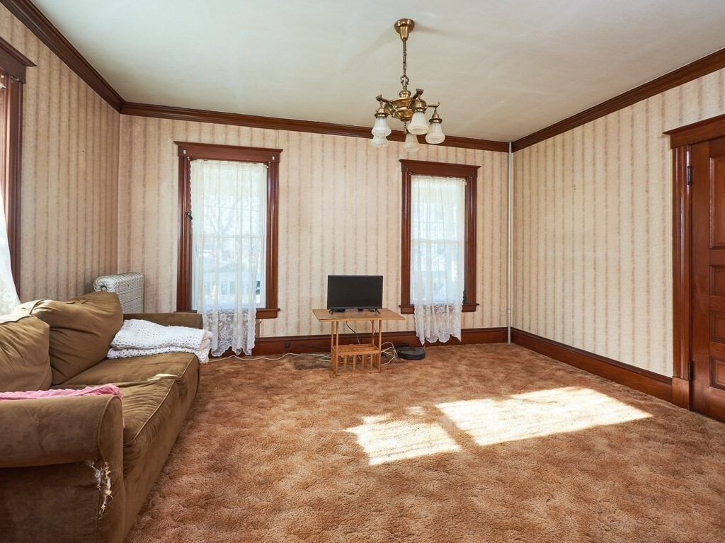 32 Wayne Street Worcester, MA 01603 - Photo 15 of 35 a living room with furniture and a chandelier