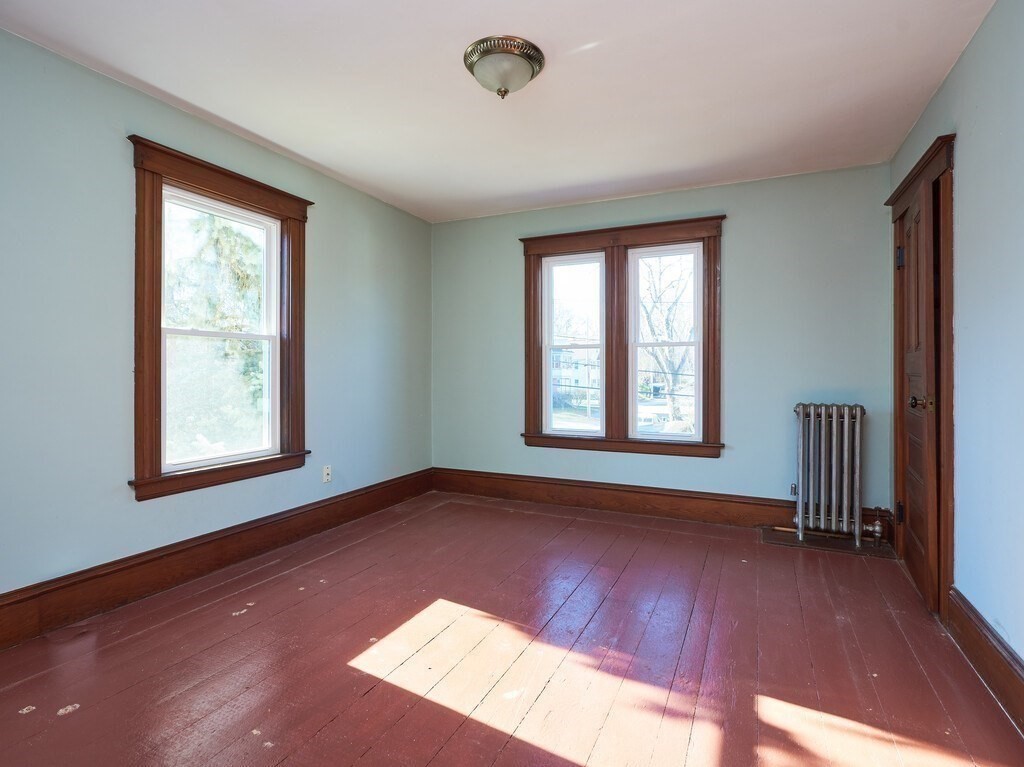 32 Wayne Street Worcester, MA 01603 - Photo 21 of 35 a view of an empty room with wooden floor and a window