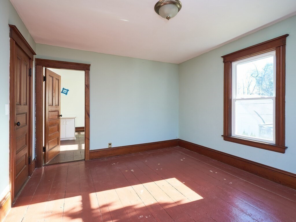 32 Wayne Street Worcester, MA 01603 - Photo 22 of 35 a view of an empty room with wooden floor and a window