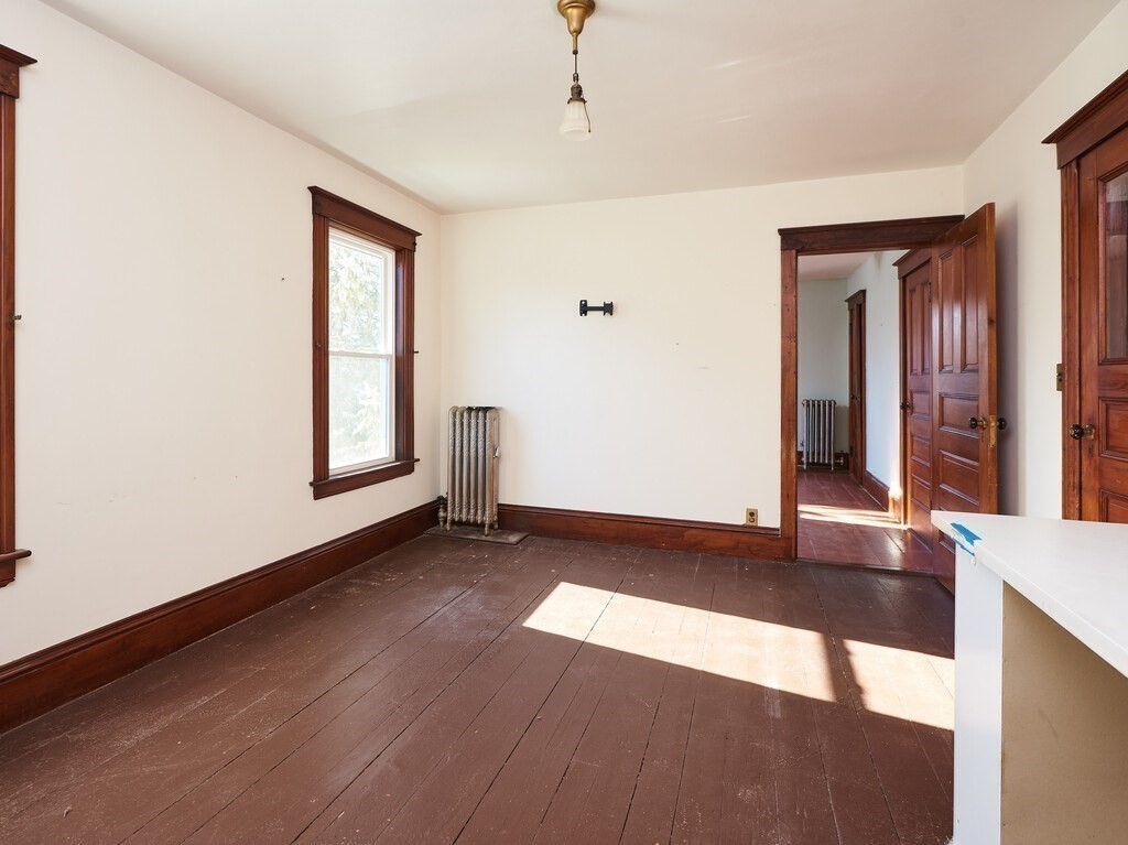 32 Wayne Street Worcester, MA 01603 - Photo 24 of 35 an empty room with wooden floor and windows