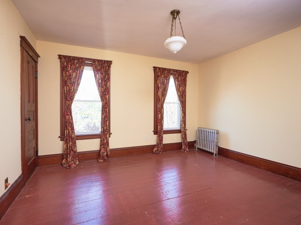 32 Wayne Street Worcester, MA 01603 - Photo 25 of 35 a view of an empty room with a window and wooden floor