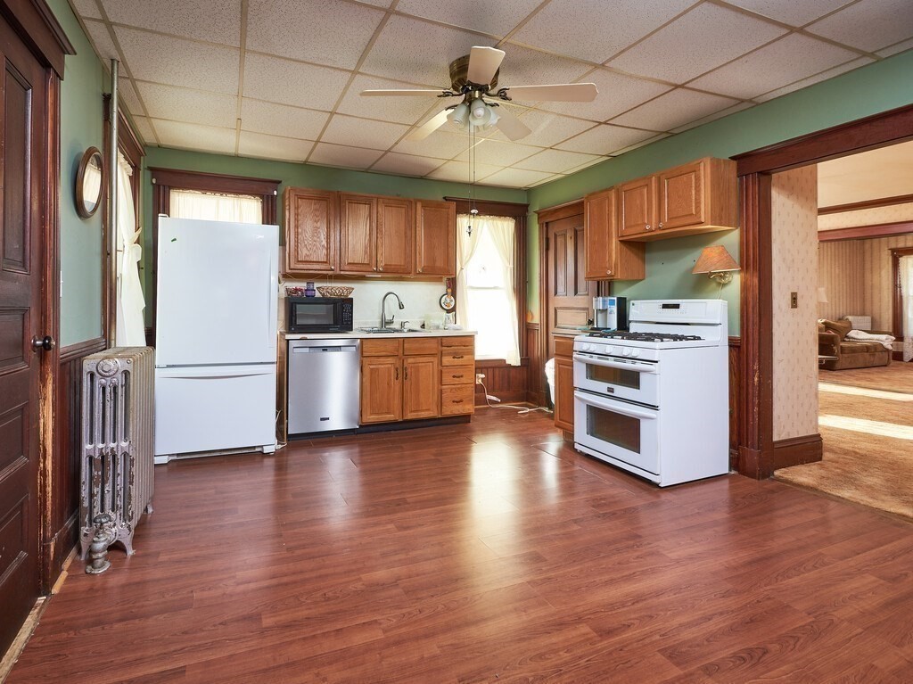 32 Wayne Street Worcester, MA 01603 - Photo 5 of 35 a kitchen with a refrigerator and a stove top oven