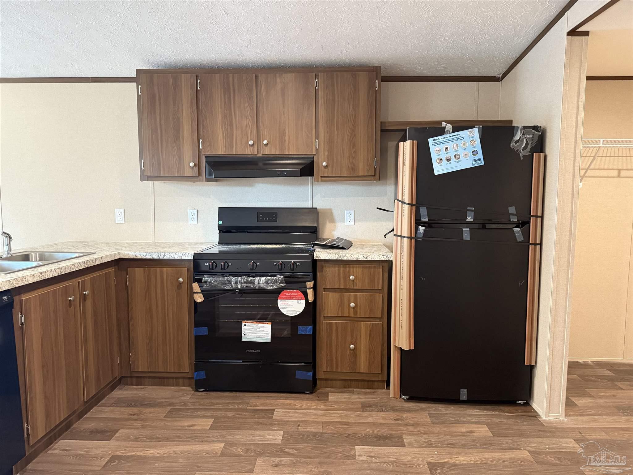 4460 Custer Lane Jay, FL 32565 - Photo 3 of 16 a kitchen with a refrigerator and a stove