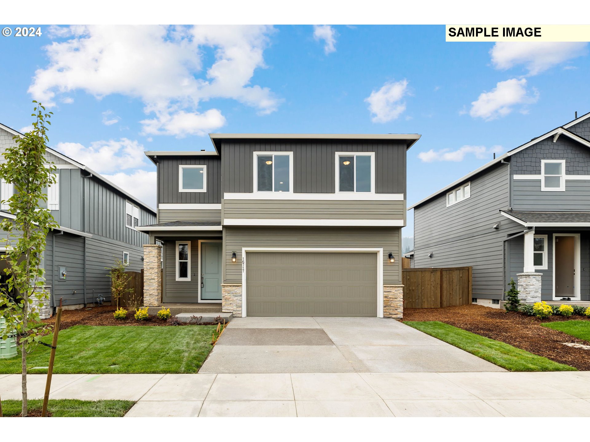 101 South 87th Avenue, Unit 4 Ridgefield, WA 98642 - Photo 1 of 32 a front view of a house with a yard and garage