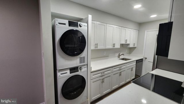 a utility room with sink dryer and washer