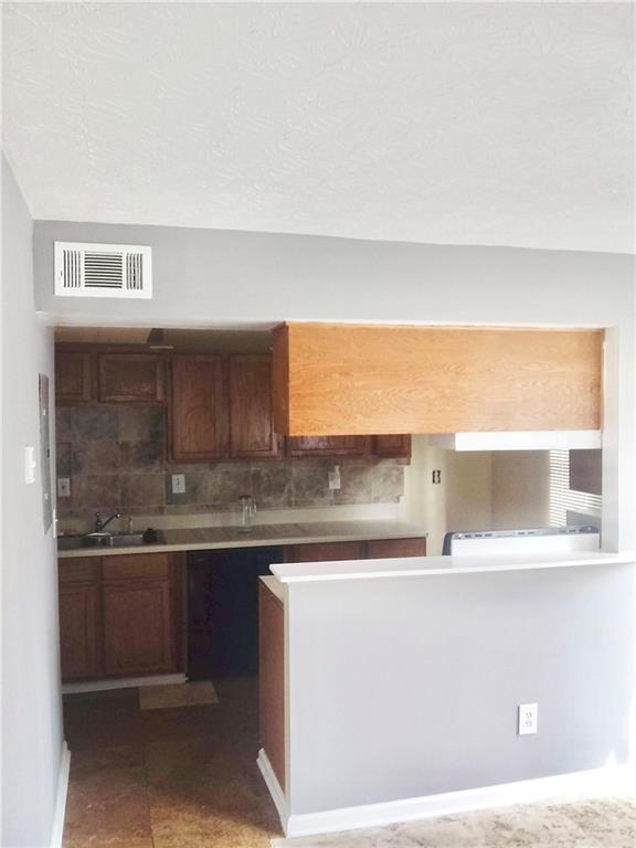 3148 Nectarine Circle Decatur, GA 30034 - Photo 5 of 10 a kitchen with stainless steel appliances granite countertop a sink and a wooden cabinets