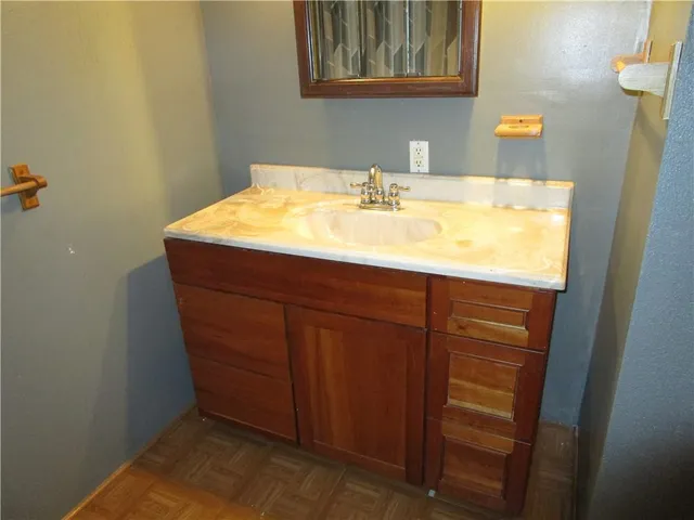 a bathroom with a sink and a mirror