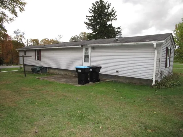 a backyard of a house with table and chairs