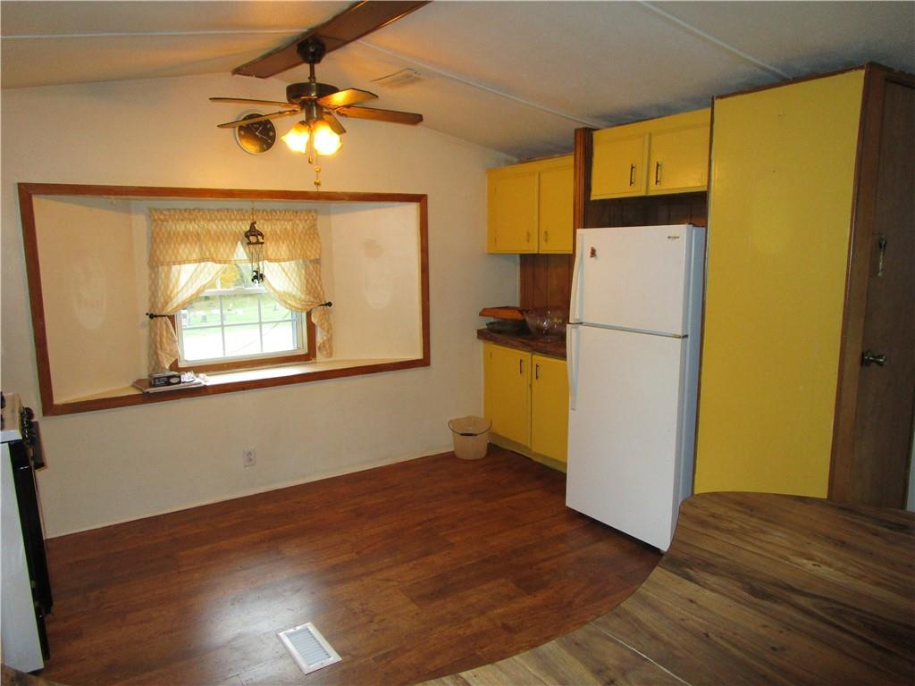 3025 South Keel Ridge Road Hermitage, PA 16148 - Photo 6 of 19 a view of a kitchen with a refrigerator a microwave and a ceiling fan