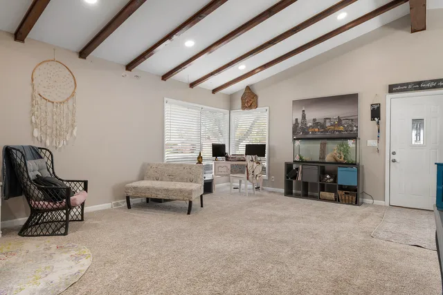 a living room with furniture and a gym machine
