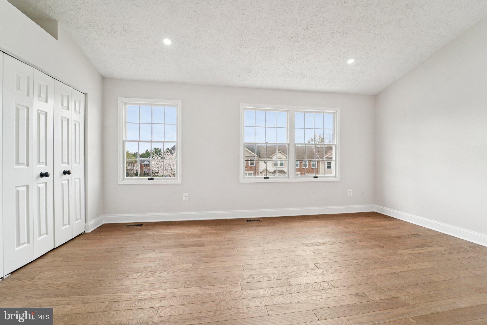 8727 Silver Hall Road Perry Hall, MD 21128 - Photo 16 of 35 an empty room with wooden floor and windows