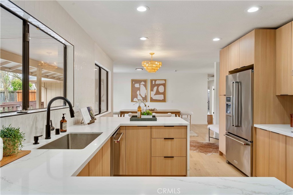 931 Camino Ramon Danville, CA 94526 - Photo 30 of 67 a kitchen with stainless steel appliances kitchen island granite countertop a sink refrigerator and cabinets