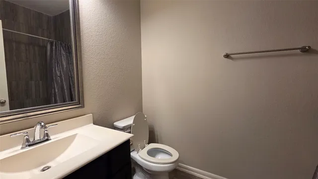 a bathroom with a sink a toilet a mirror and vanity