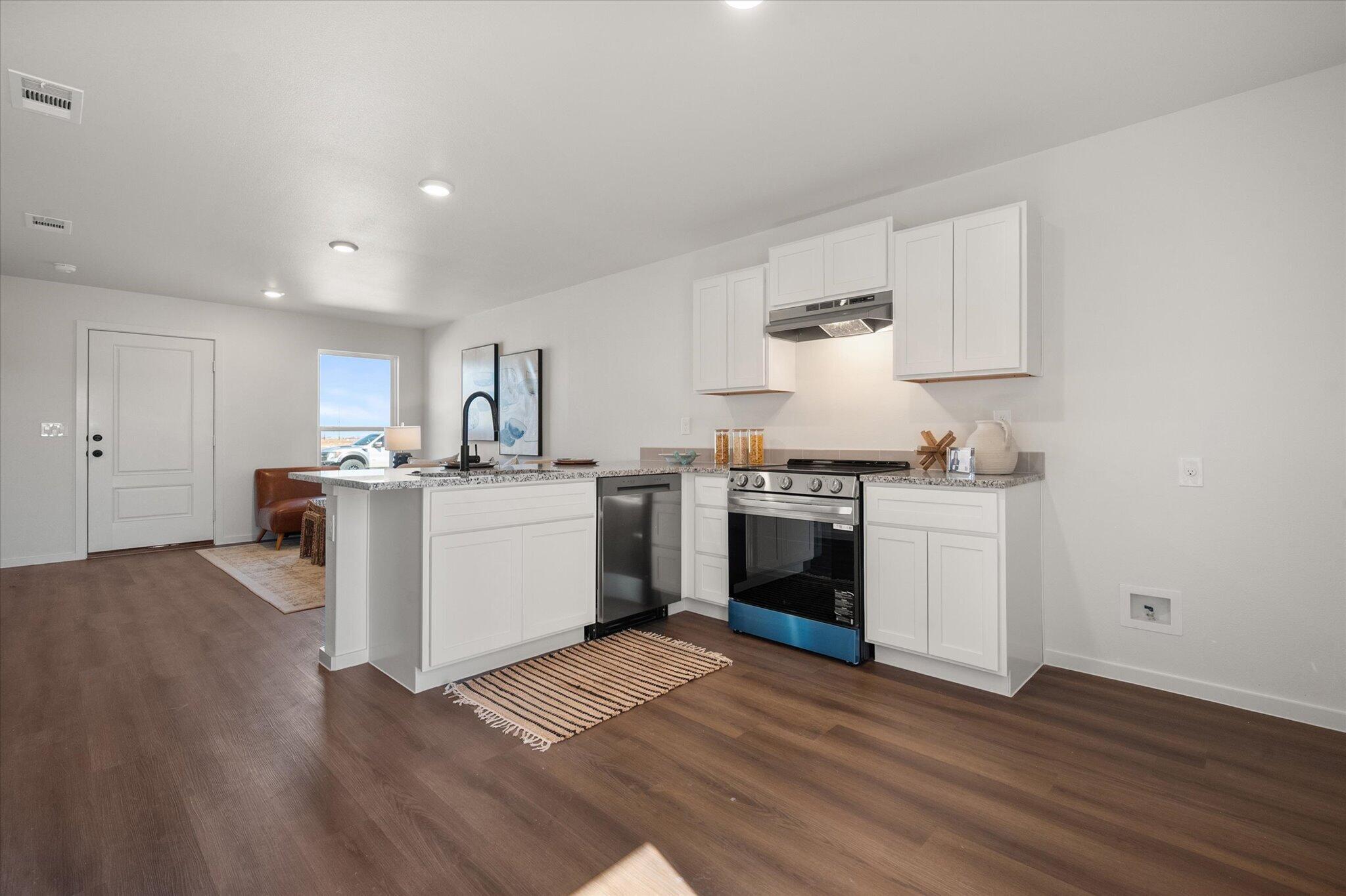 5505 Smith Street Lubbock, TX 79416 - Photo 11 of 18 a kitchen with granite countertop a sink cabinets and stainless steel appliances