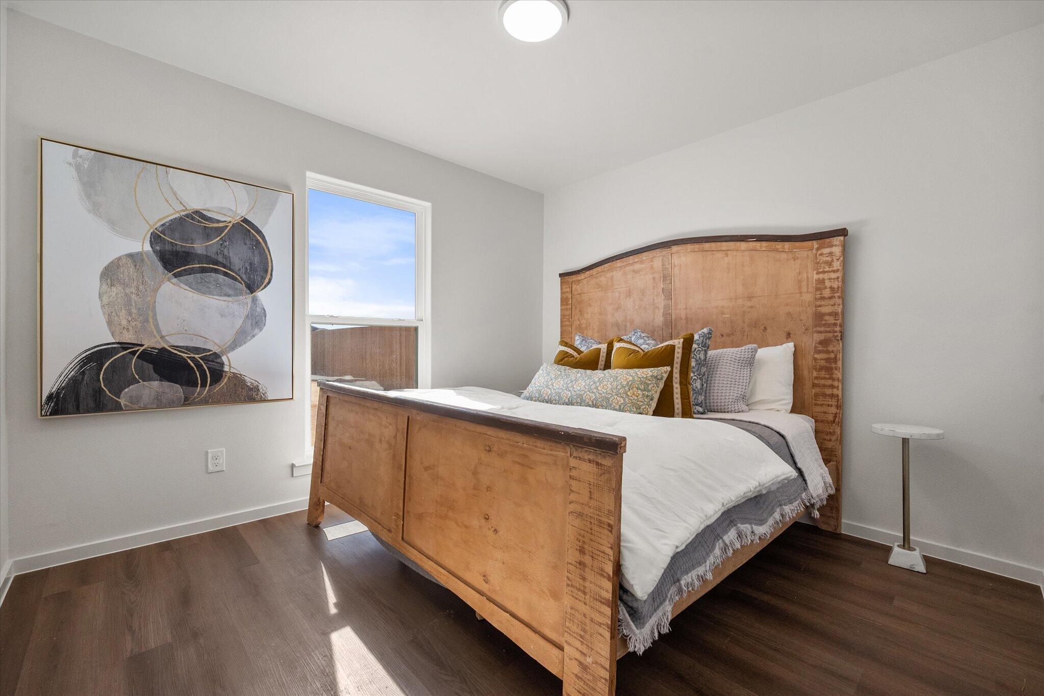 5505 Smith Street Lubbock, TX 79416 - Photo 15 of 18 a bedroom with a bed and wooden floor