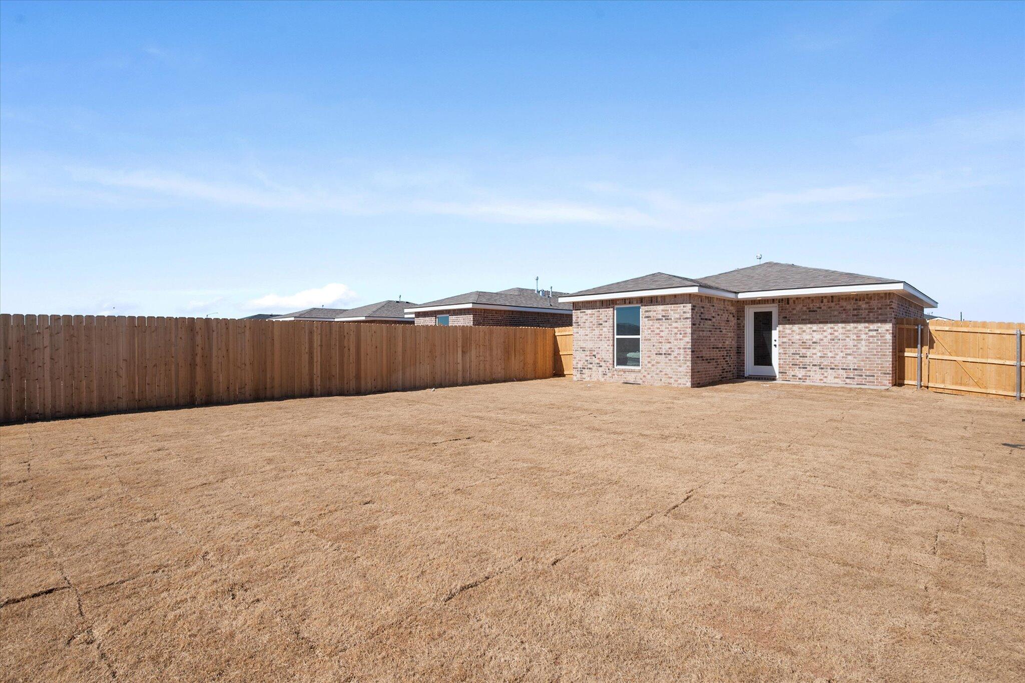 5505 Smith Street Lubbock, TX 79416 - Photo 16 of 18 a view of a house with a yard