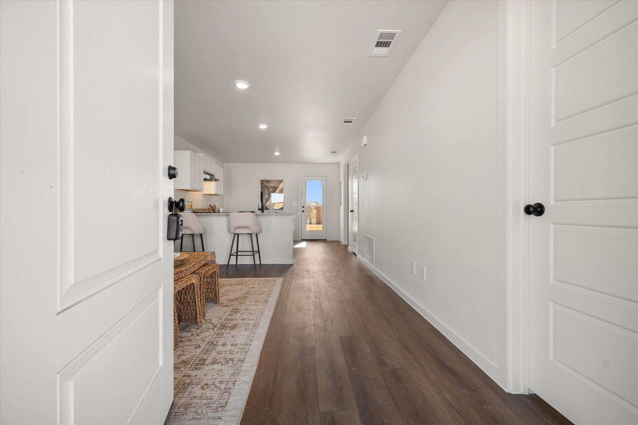 5505 Smith Street Lubbock, TX 79416 - Photo 2 of 18 a view of a hallway with wooden floor