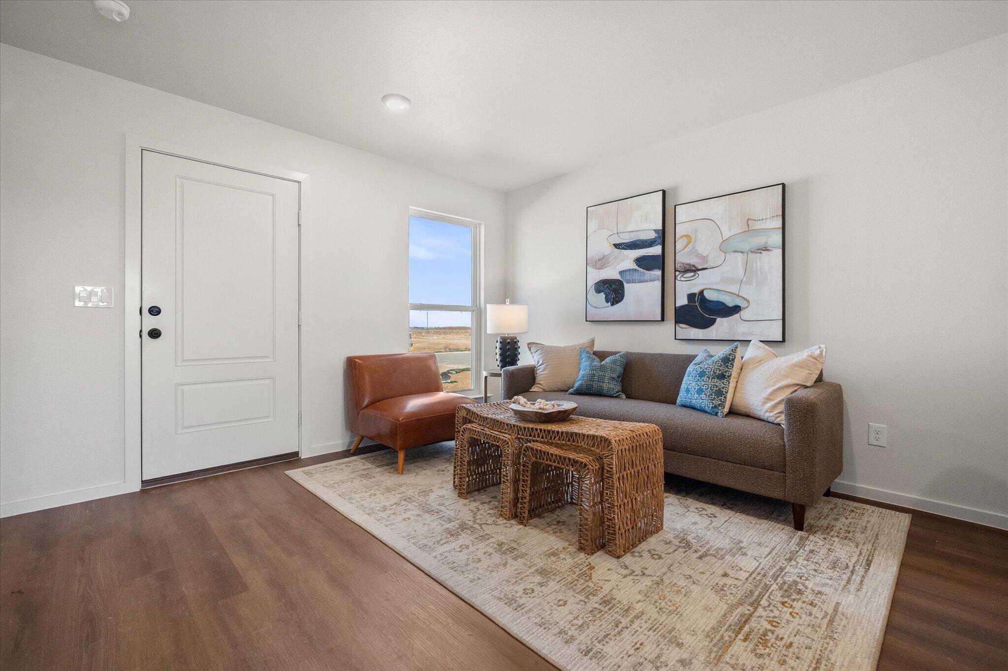 5505 Smith Street Lubbock, TX 79416 - Photo 5 of 18 a living room with furniture and a wooden floor