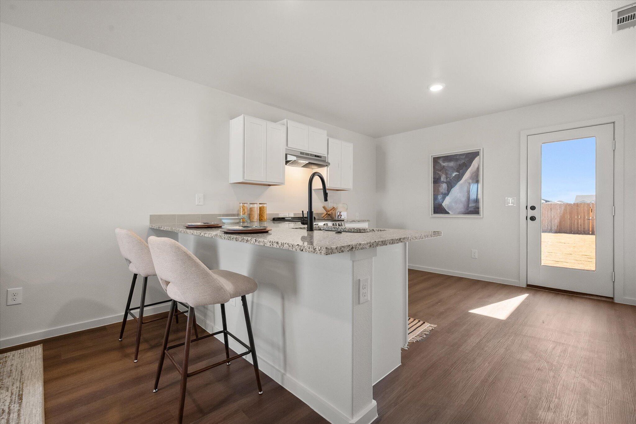 5505 Smith Street Lubbock, TX 79416 - Photo 8 of 18 a kitchen with a table and chairs