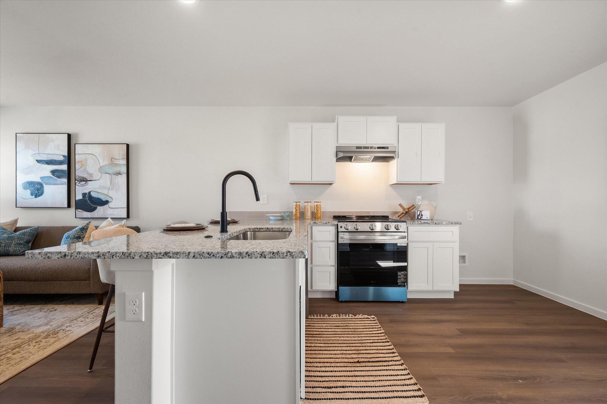 5505 Smith Street Lubbock, TX 79416 - Photo 9 of 18 a kitchen with a stove and a sink