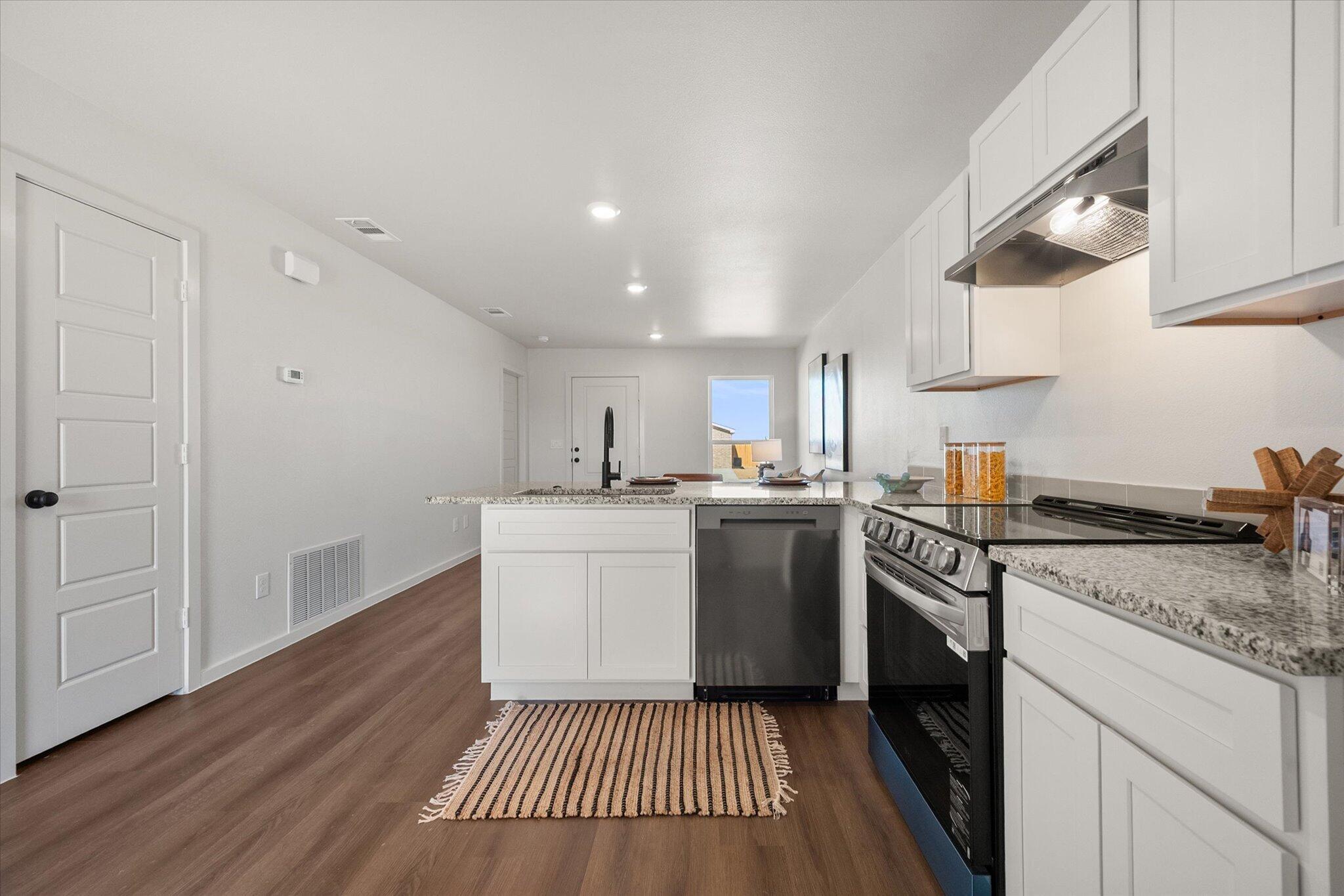 5505 Smith Street Lubbock, TX 79416 - Photo 10 of 18 a kitchen with a sink and a stove top oven
