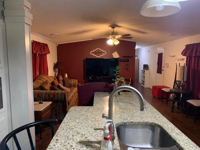 a kitchen with stainless steel appliances granite countertop a sink refrigerator and cabinets