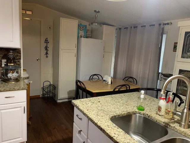 a view of a dining room with a table and chairs