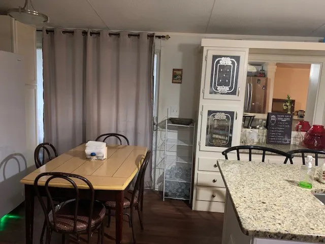 a view of a dining room with furniture and window