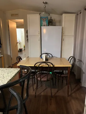 a dining table with chairs and wooden floor