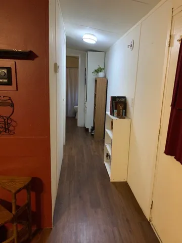 a view of living room with furniture and a lamp