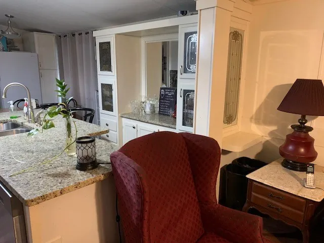 a view of a livingroom with furniture a flat screen tv and wooden floor