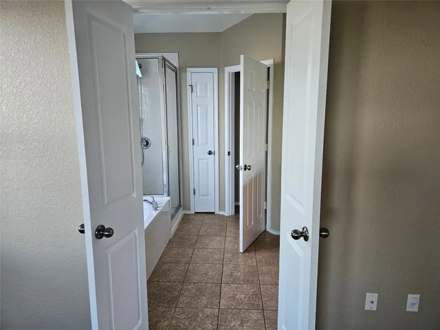 a view of a bathroom with a shower and a sink