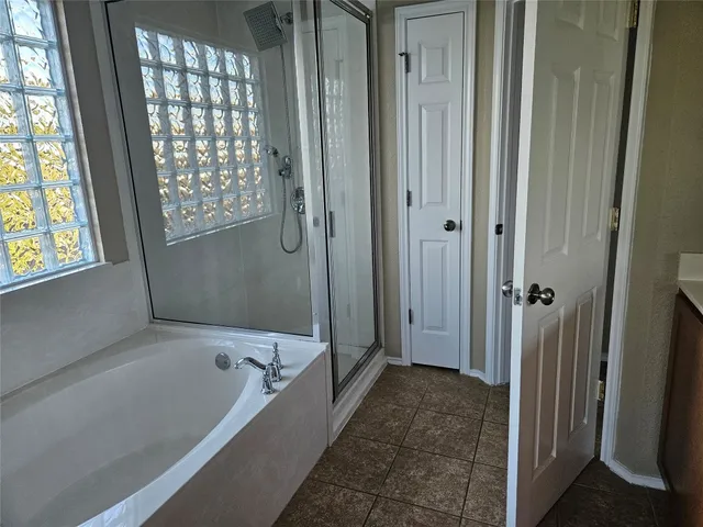 a bathroom with a bathtub and a shower