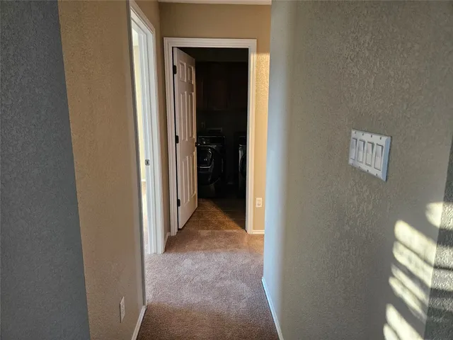 a view of a hallway to rooms