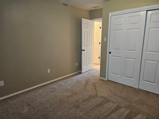 an empty room with closet area