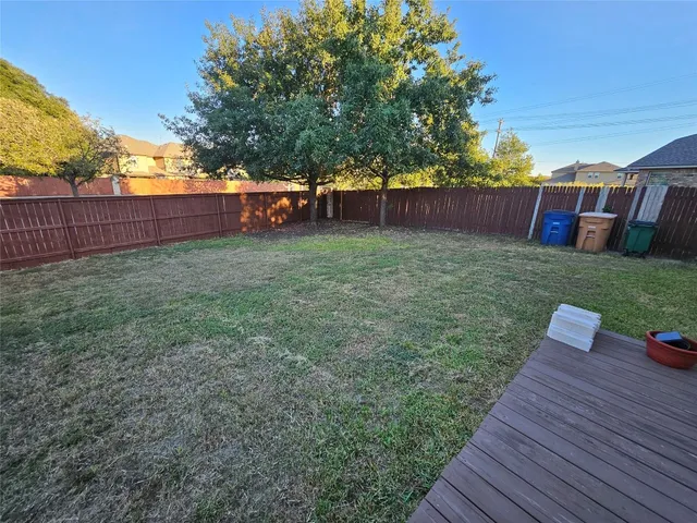 a backyard of a house with wooden floor