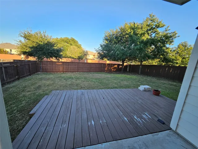 a view of outdoor space and deck with patio