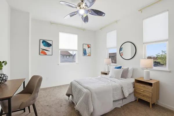a bedroom with a bed and a window