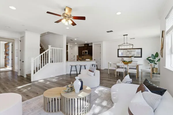 a living room with furniture a fireplace and a chandelier