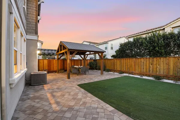 a view of a backyard with sitting area