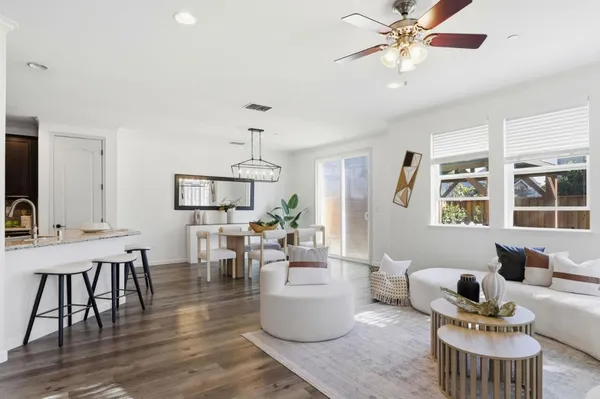a living room with furniture and wooden floor