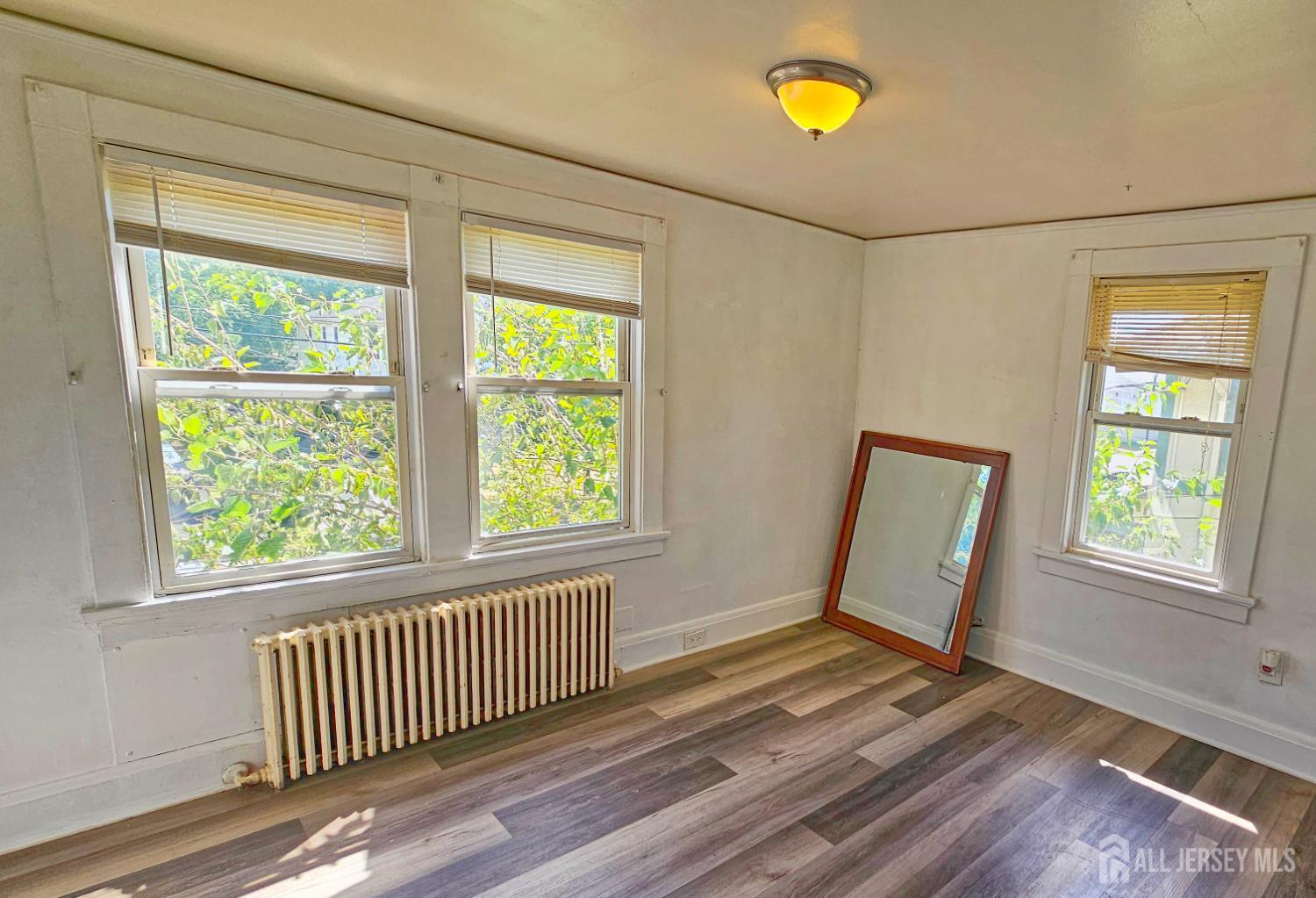 417 B Chestnut Street Middlesex, NJ 08846 - Photo 6 of 9 a view of empty room with wooden floor and fan