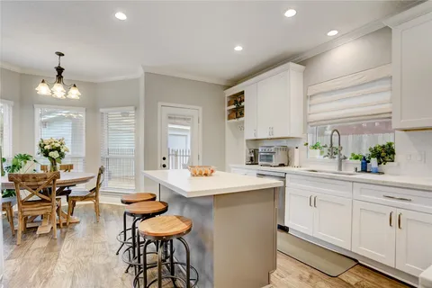 a spacious bathroom with a shower a sink and a mirror