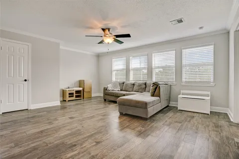 a bed sitting in a spacious bedroom next to a window