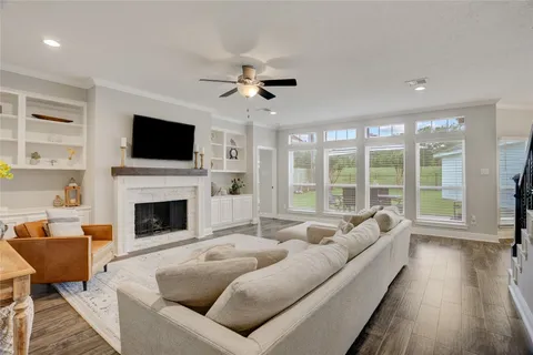 a living room with furniture a fireplace and a flat screen tv