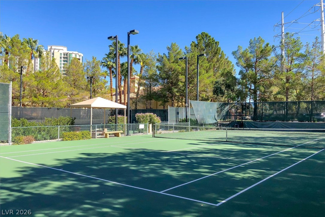 220 East Flamingo Road, Unit 305 Las Vegas, NV 89169 - Photo 18 of 26 Ready for a match, this community tennis court is framed by mature landscaping and clear skies.